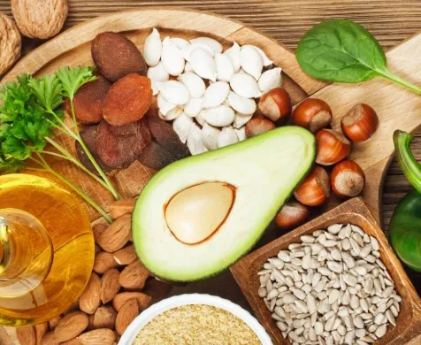 Nuts, seeds, avocado and dried fruit on a board