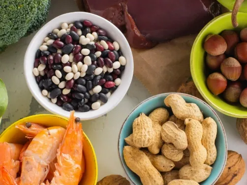 Beans, nuts, peanuts and fish in bowls